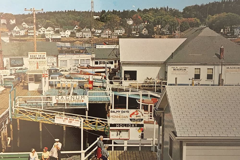 Fishing dock area with shops and buildings and signage from the 1950's